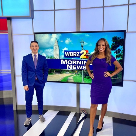On the right side of the image, Tristen land, they were wearing purple dresses, and on the right side of the image, her office anchor mate was posing for the photo.